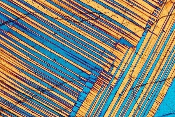 beautiful mineral rocks in microview: A diorite from Adamello, Italy. This feldspar has the double crystal structure.